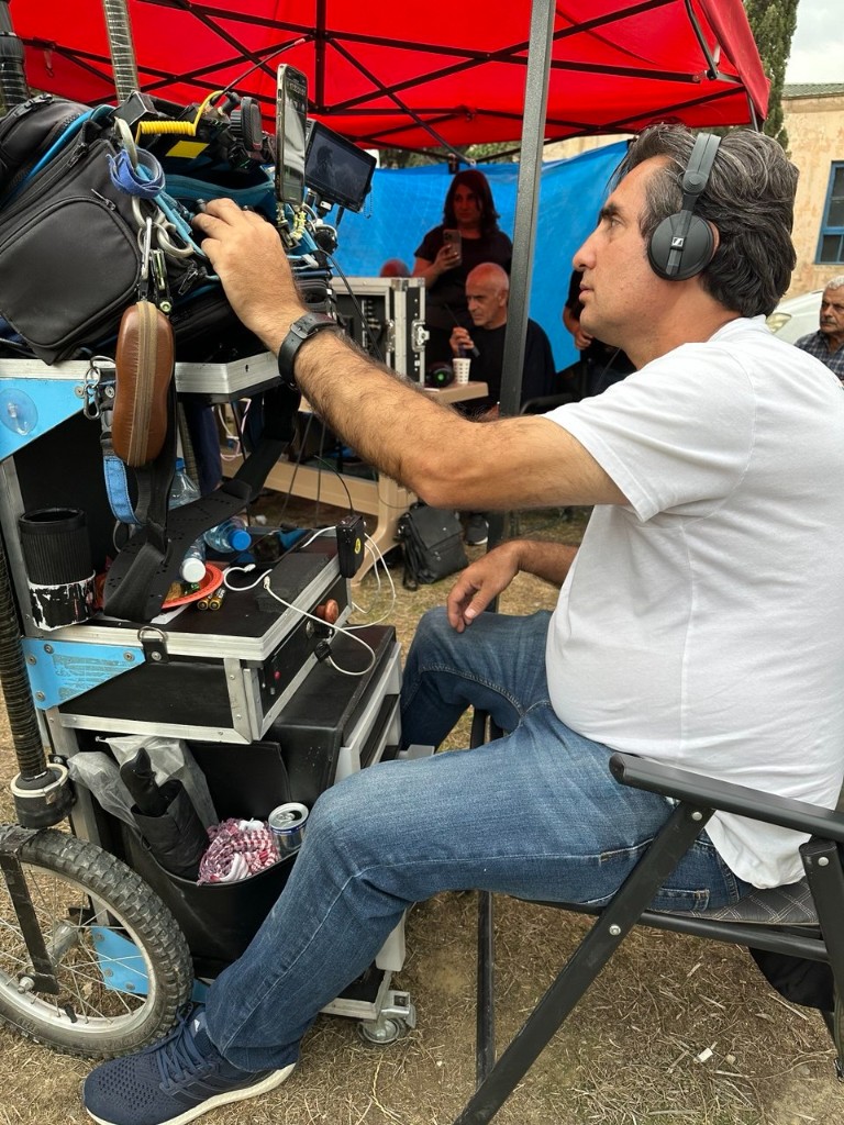 Akinak unit — sound recordist at the cart under a red canopy between takes