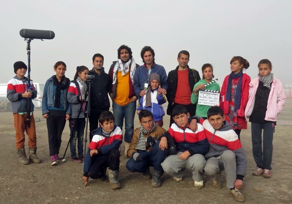 A Flag Without a Country cast and crew with clapperboard and boom on a foggy location