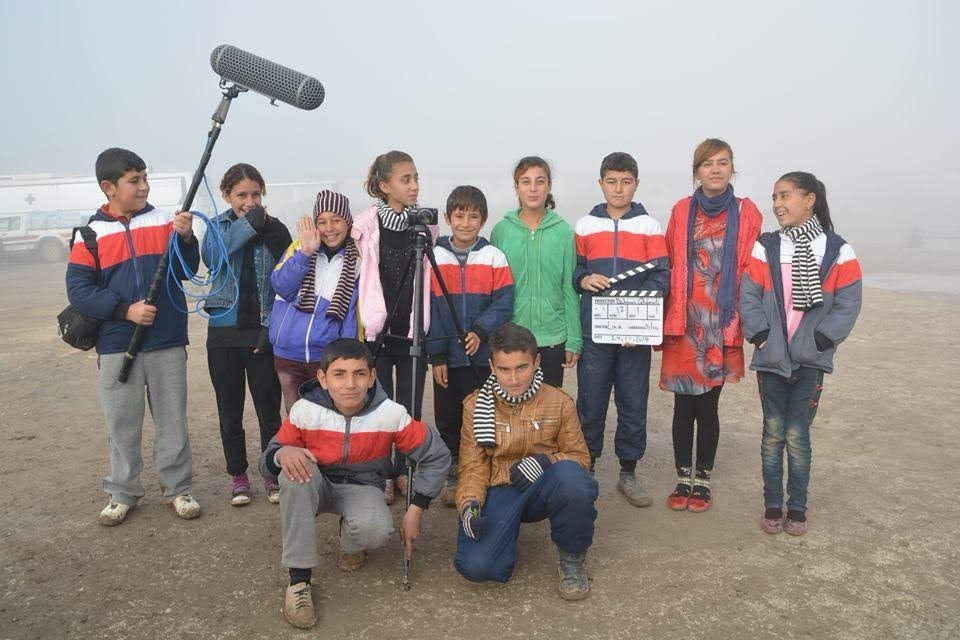 A Flag Without a Country — young cast with boom, camera, and slate in the fog