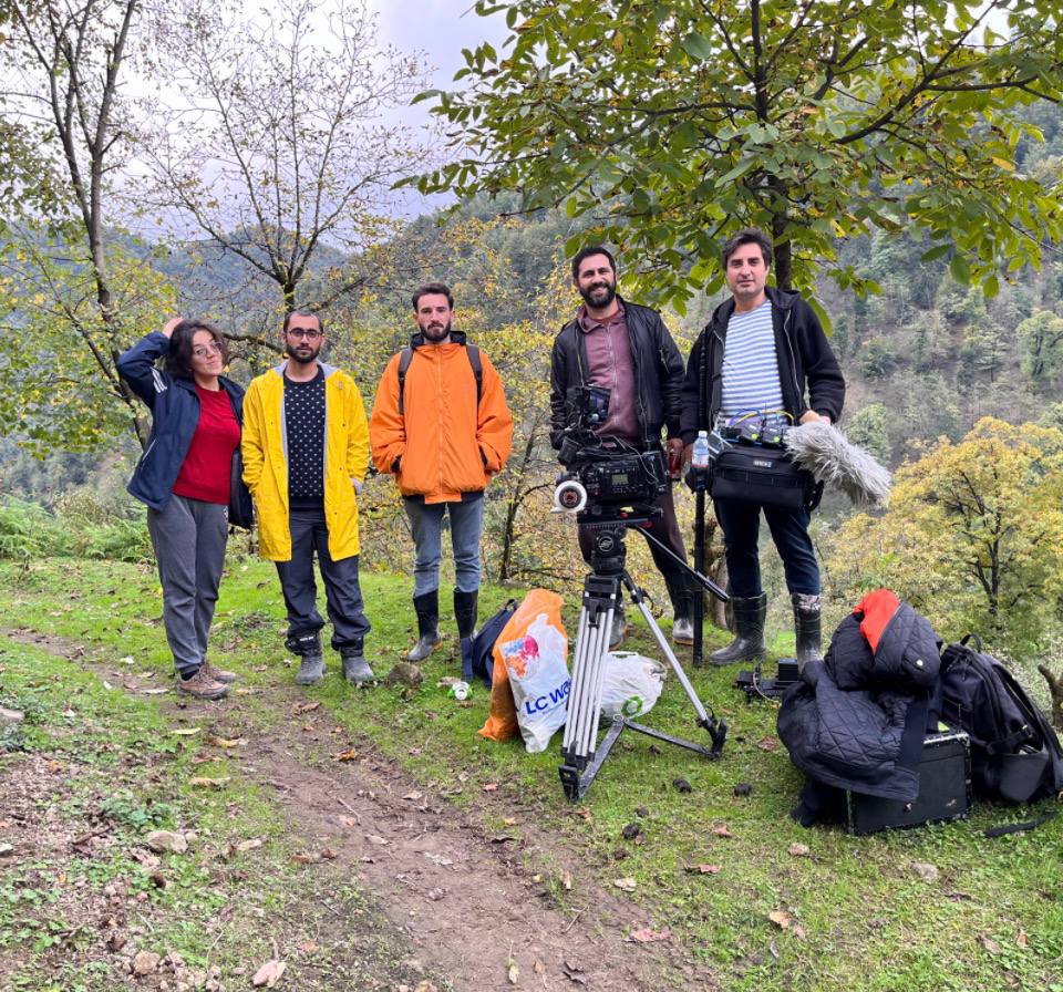 Camera and sound crew on a mountain path