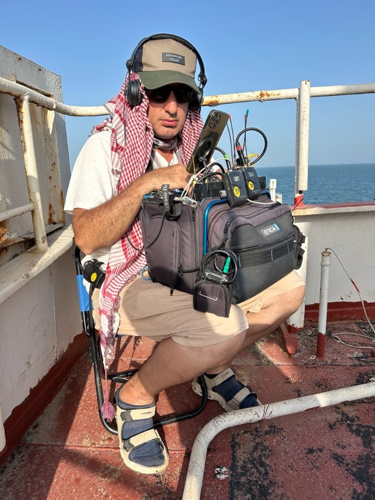 Şövkət unit — sound recordist with Orca bag and wireless receivers on the ship deck