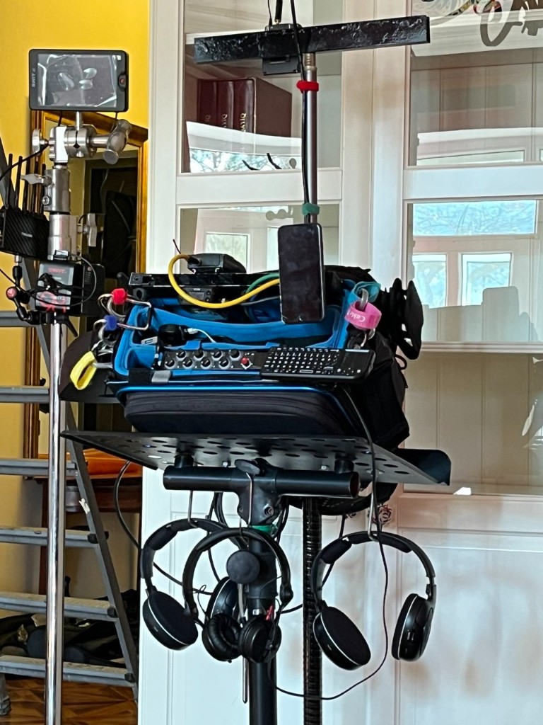 Sound mixer bag on a stand with headphones and SWIT monitor — kit roll